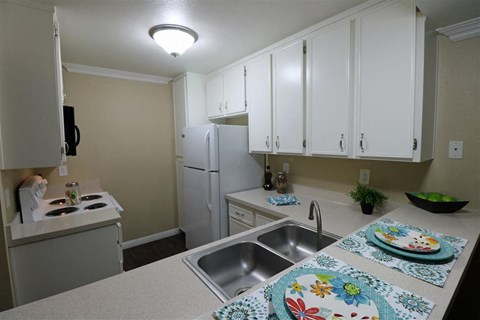 a kitchen with a sink and a refrigerator